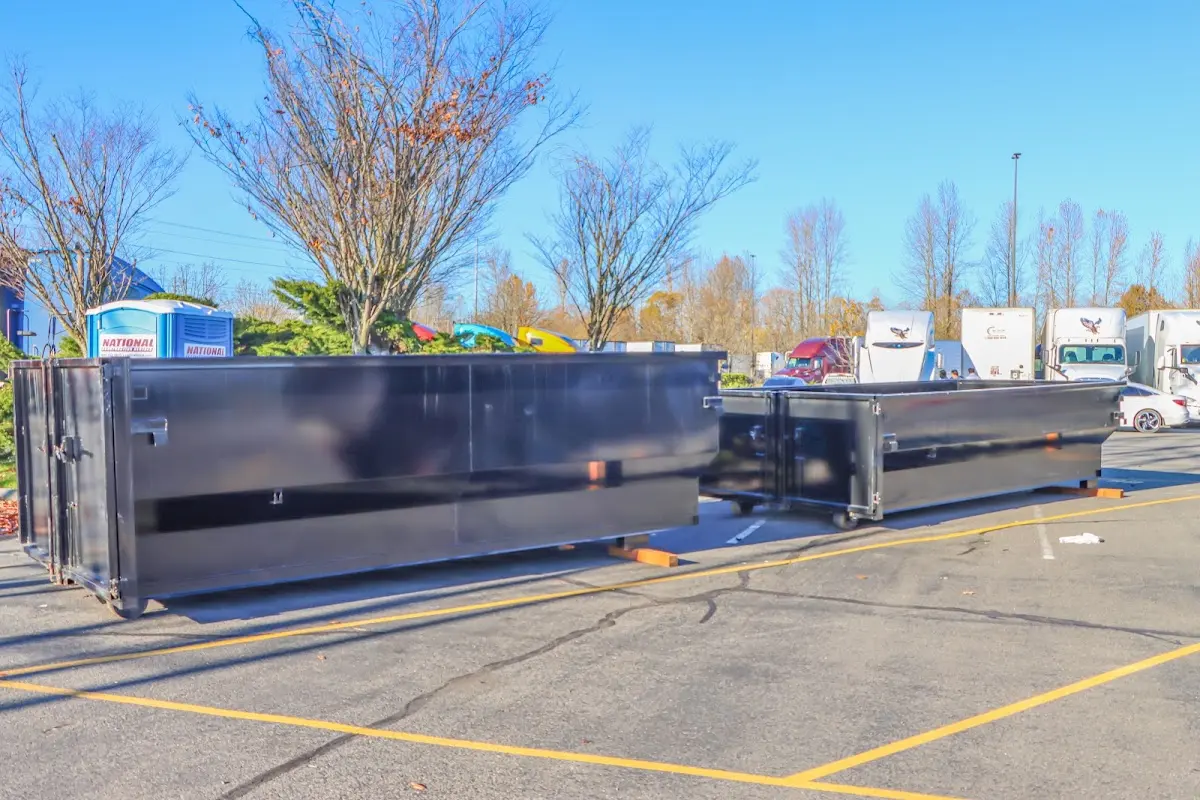 Professional dumpster rental service with roll-off container on residential driveway in Anacortes